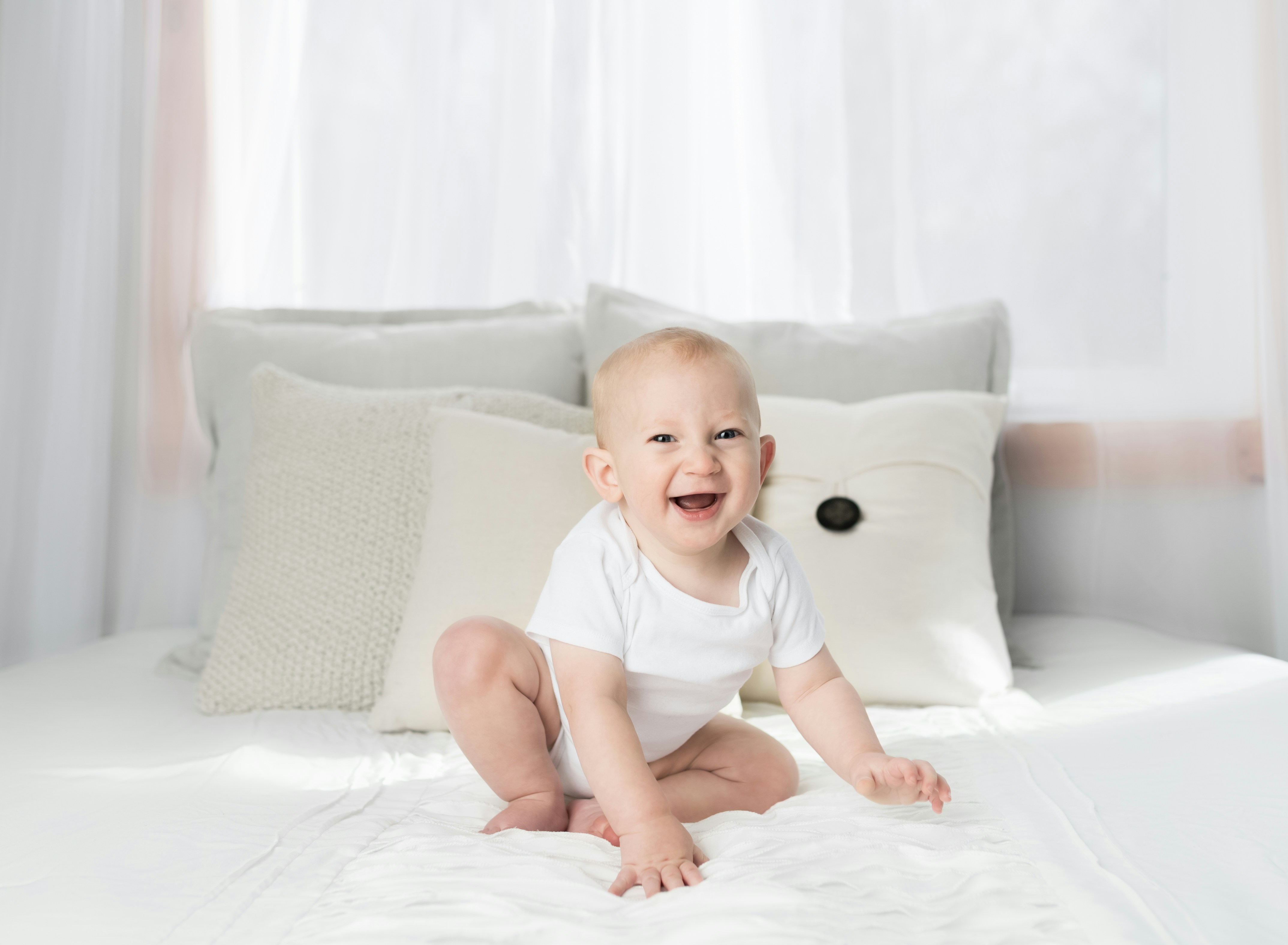 baby minimal white background laughing